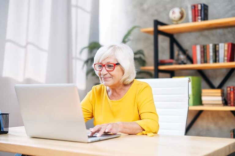Older woman using laptop at home